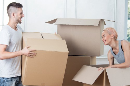 Removal team unloading boxes at a property in North London