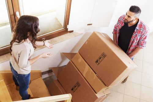 Boxes and furniture being loaded into a van for relocation