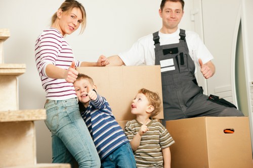 Professional movers carrying furniture through a home entrance